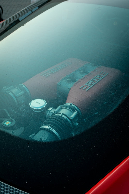 A red car with a engine in the hood