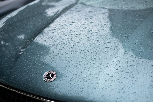 A close up of a car with rain drops on it