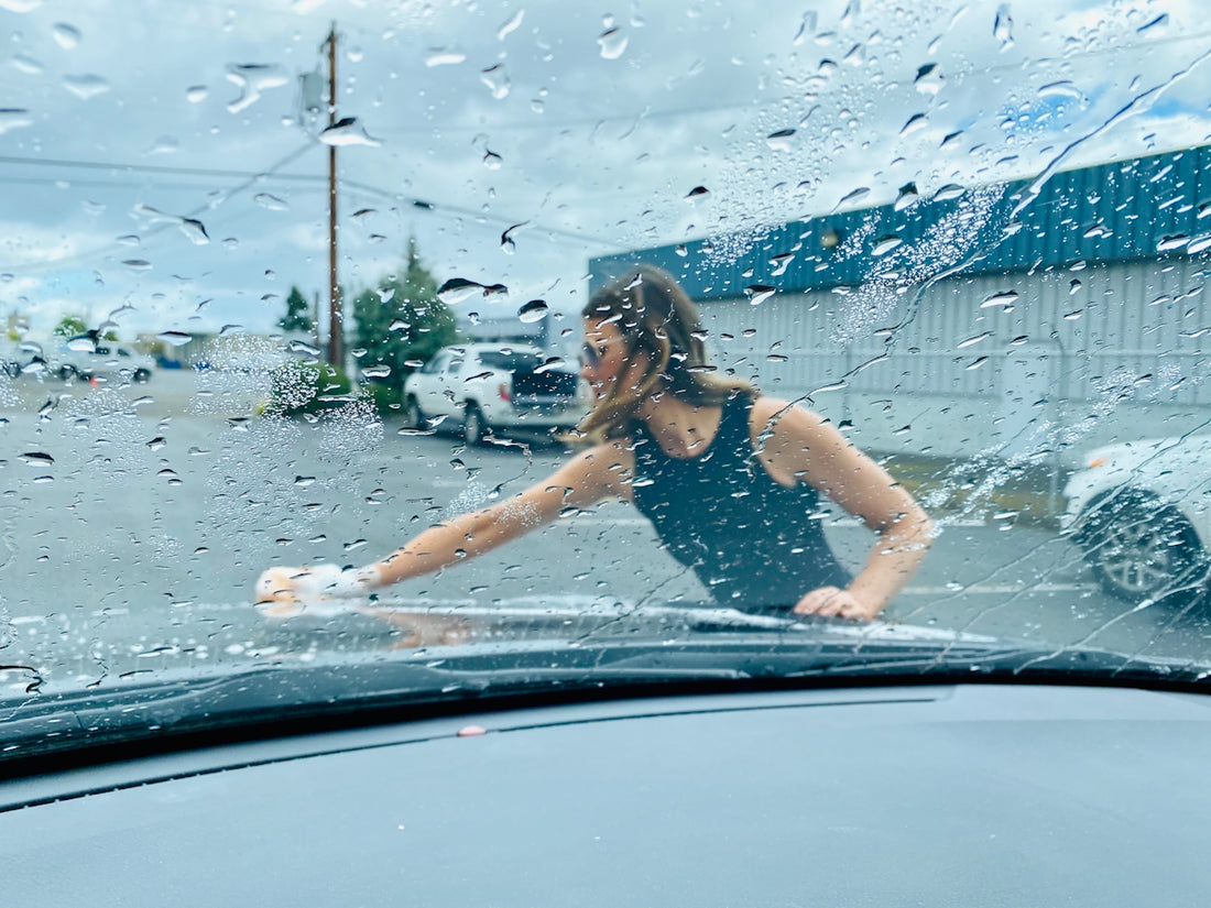woman in black and white polka dot tank top in car