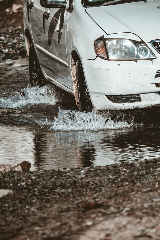 a car in a muddy puddle