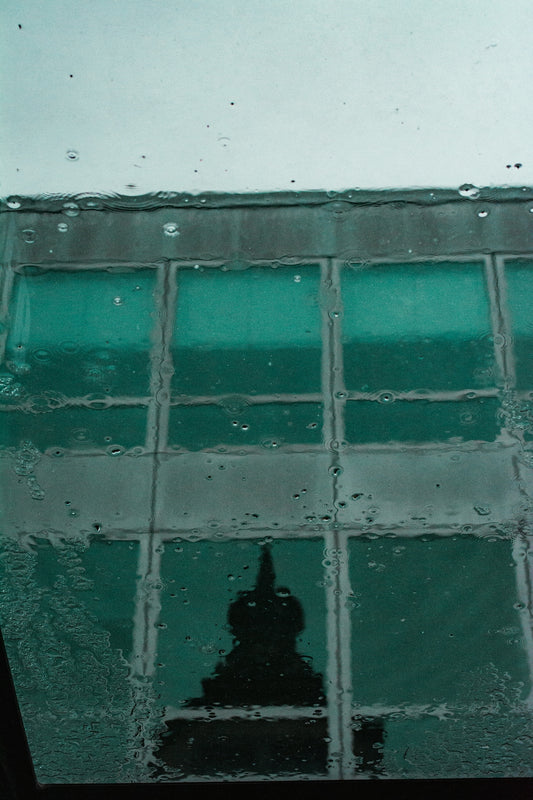 the reflection of a building in a window
