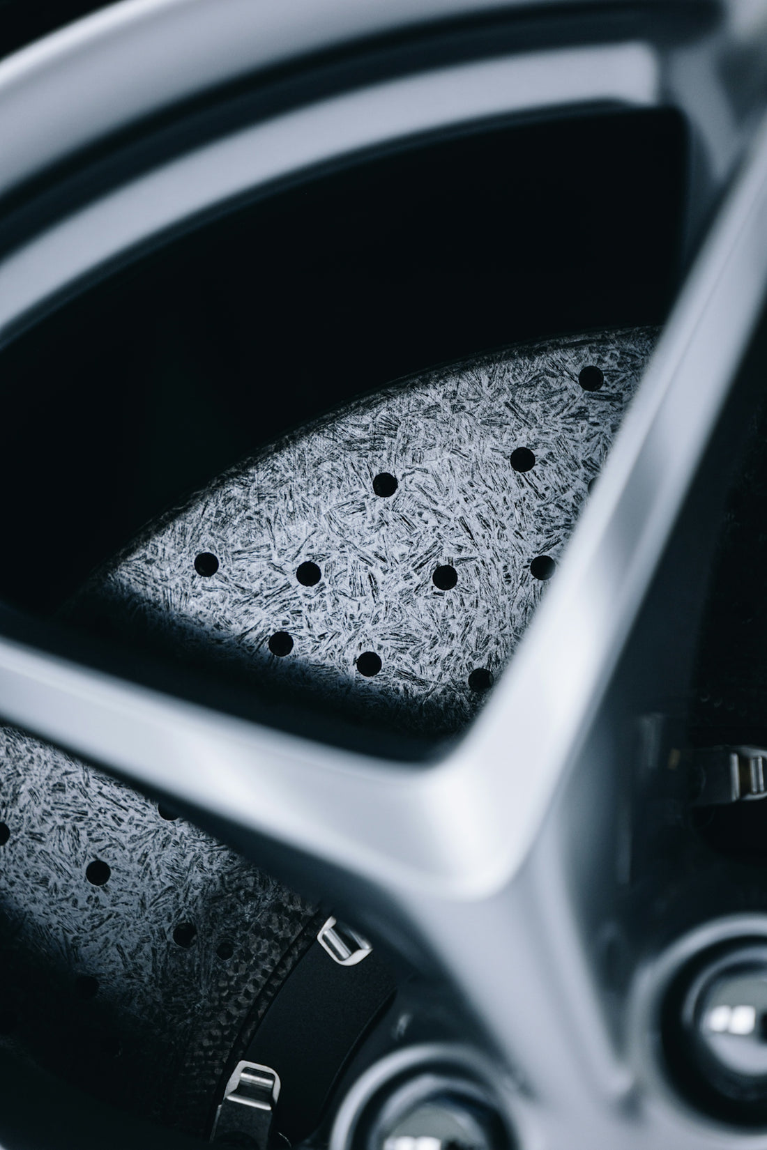 a close up of a car wheel with holes in it
