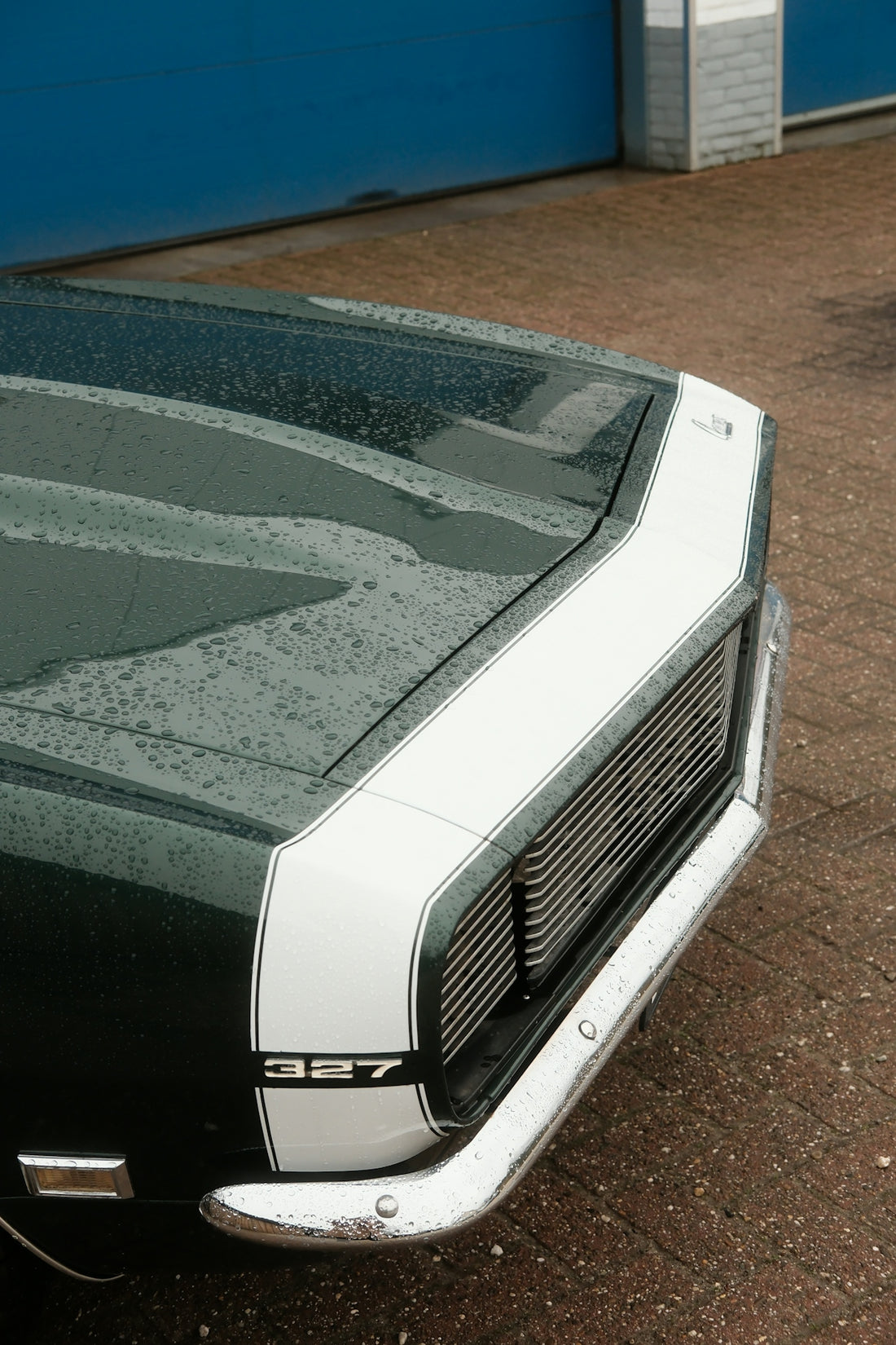 a black and white car parked in front of a garage