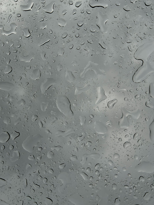 A close up of a rain covered window