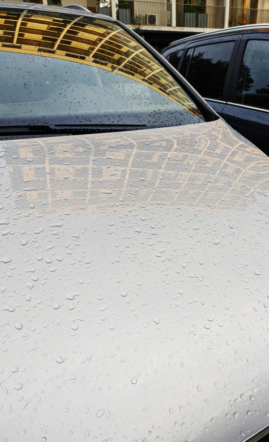 A close up of a car with rain drops on it